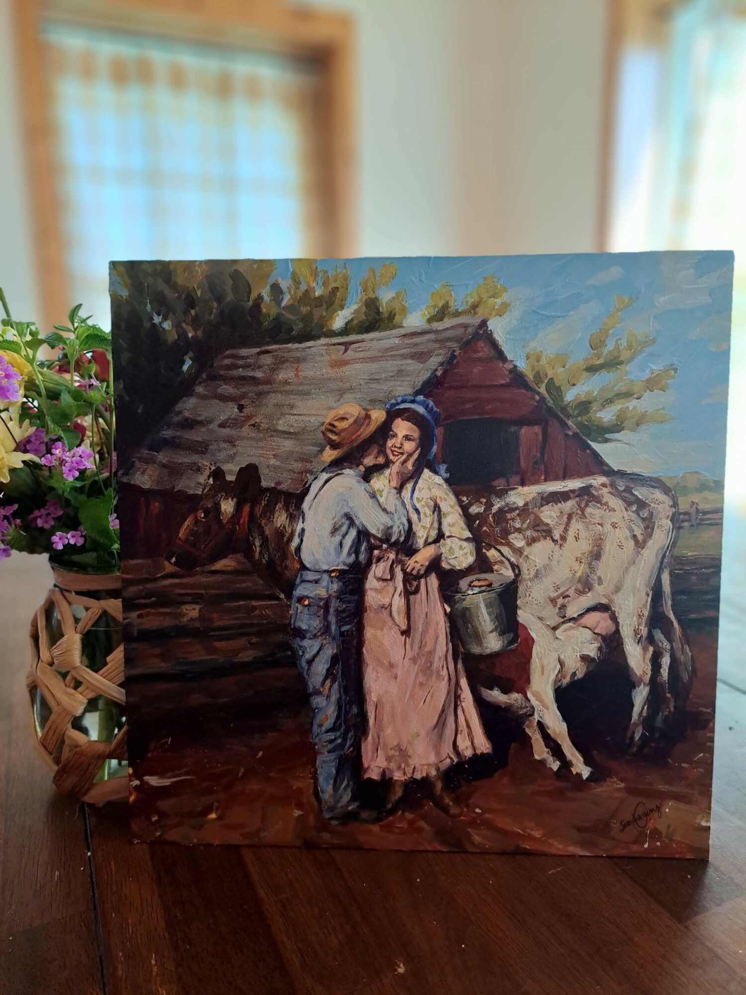 Painting of a woman in traditional clothing standing outside a wooden house with trees in the background.